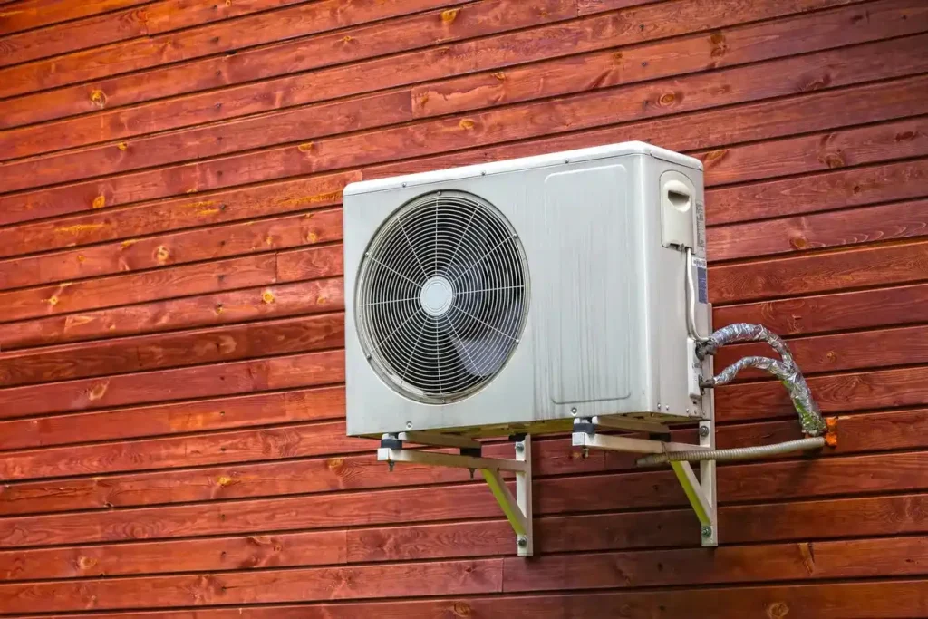 A mini split unit clamped at the wall of a home