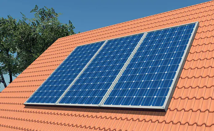 Solar panels on an orange tiled roof.