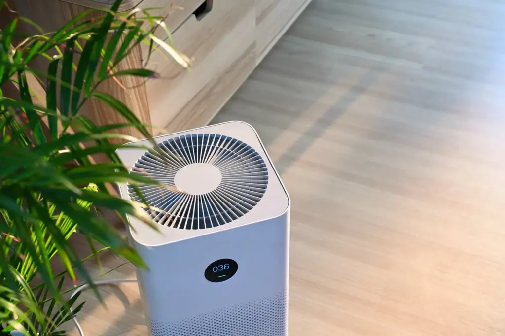 White air purifier on a wooden floor.