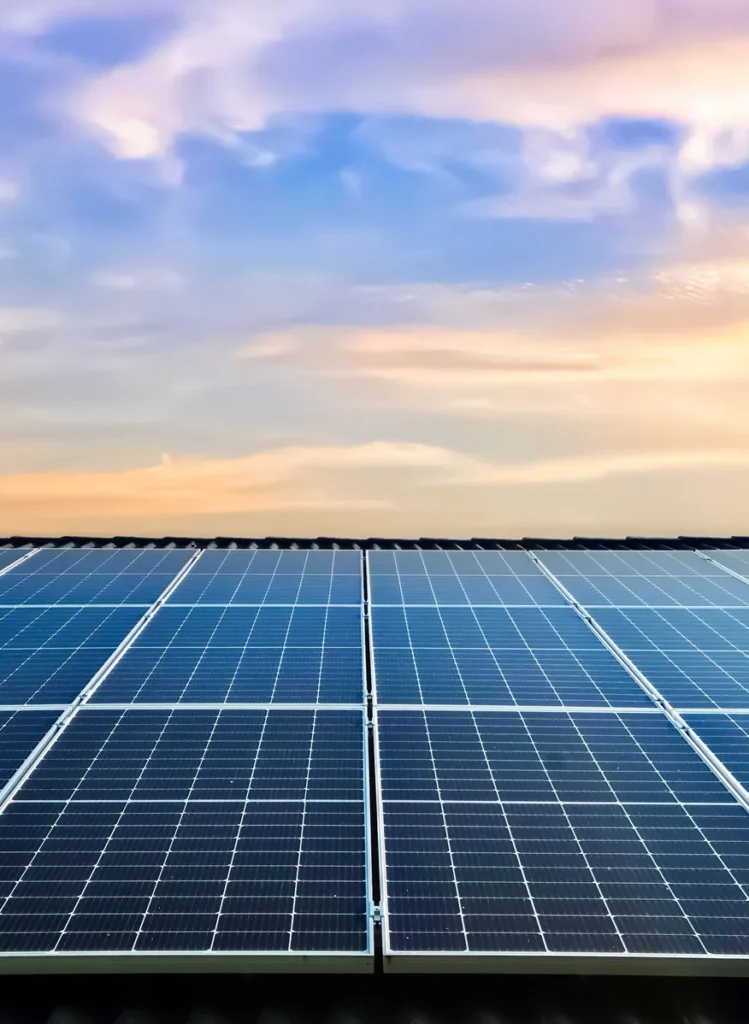Rooftop solar panels under a vibrant sky, showcasing clean energy technology in a residential or commercial setting